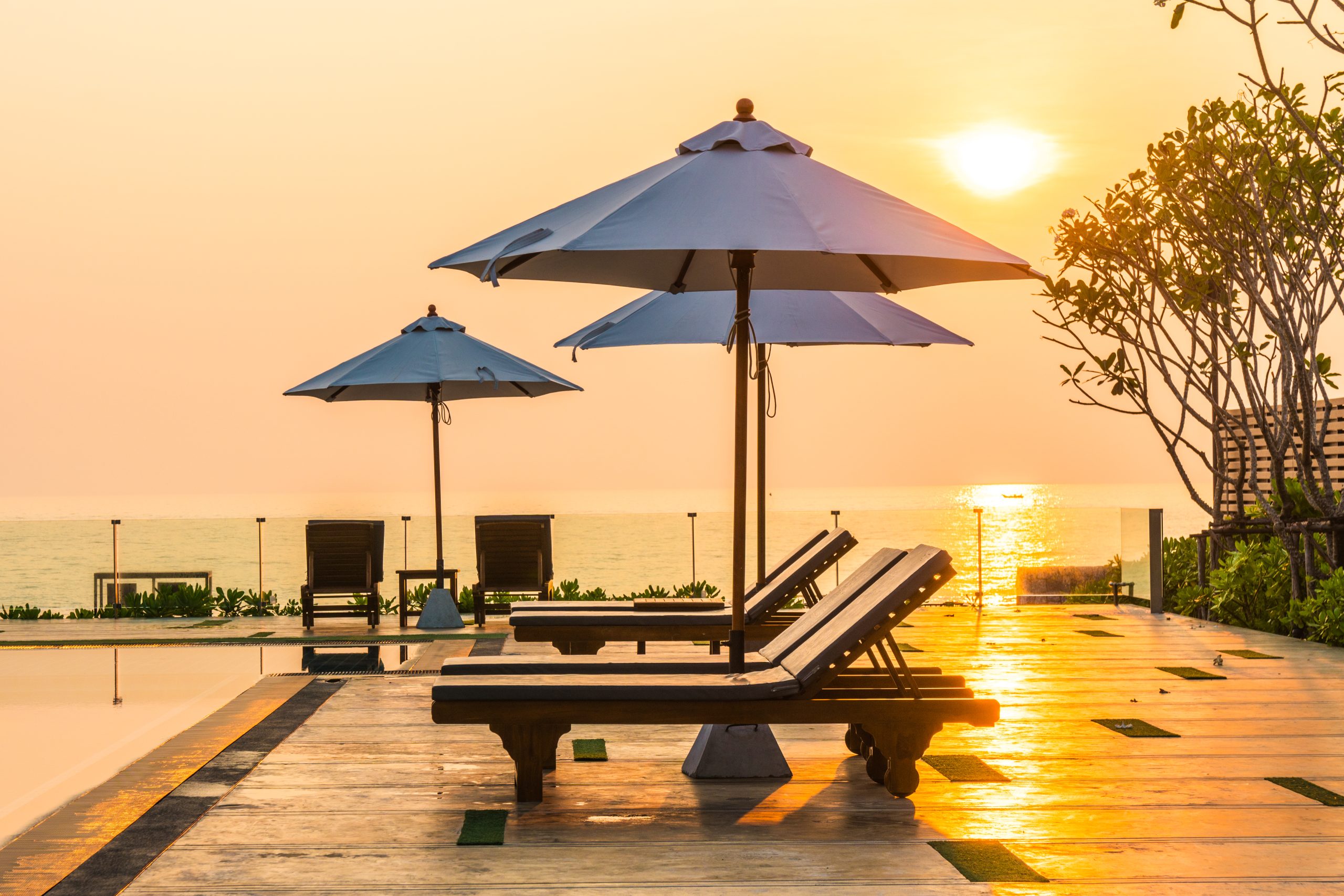Beautiful umbrella and chair around swimming pool in hotel and r Beautiful umbrella and chair around swimming pool in hotel and r
